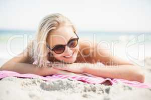 Pretty woman in bikini lying on the beach