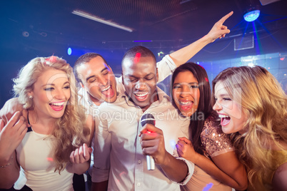 Happy friends singing at the karaoke