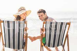 Portrait of young couple sitting on armchair