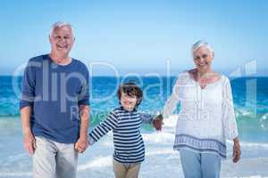 Cute boy holding his grandparents hands