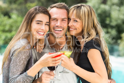 Happy man with beautiful female friends during party