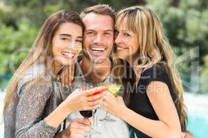 Happy man with beautiful female friends during party