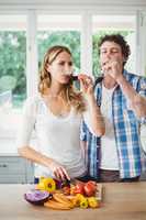 Young couple drinking wine in kitchen