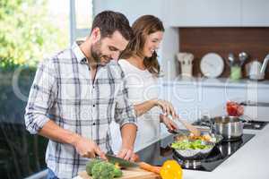 Couple preparing food at kitchen counter