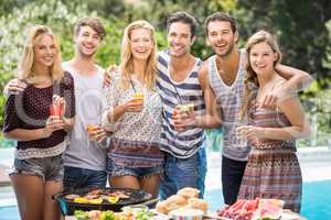 Portrait of friends having juice at outdoors barbecue party