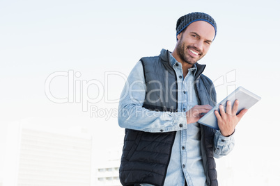 Happy young man using digital tablet