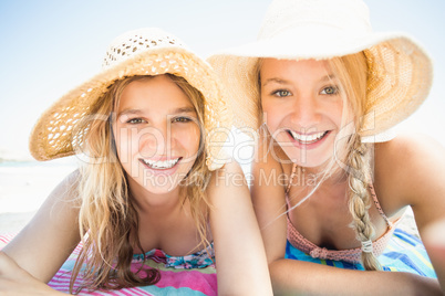 Portrait of happy women lying on the beach