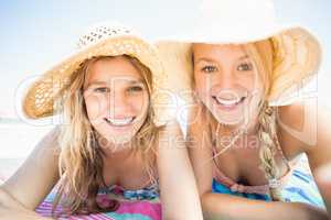 Portrait of happy women lying on the beach