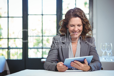 Smiling businesswoman using tablet