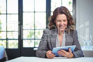 Smiling businesswoman using tablet