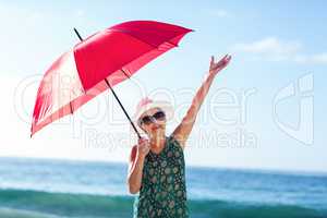 Senior woman posing with an umbrella