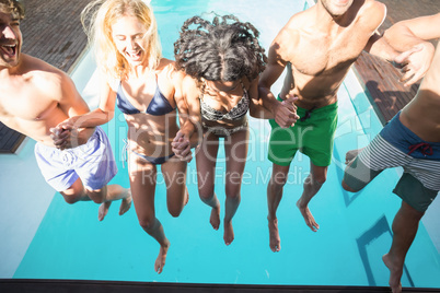 Happy friends enjoying at the swimming pool