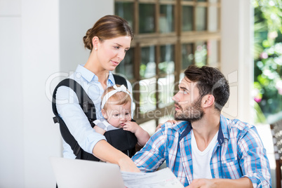 Man with documents looking at wife