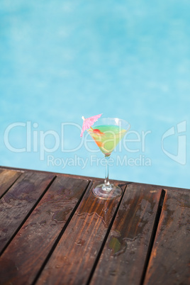 Cocktail glass on wooden deck