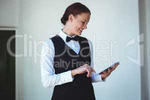 Smiling waitress using a tablet
