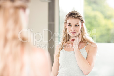 Confident woman looking in mirror