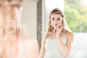 Confident woman looking in mirror