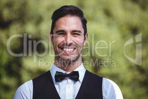 Handsome waiter smiling at camera