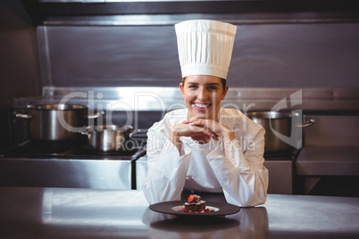 Chef leaning on the counter with a dish