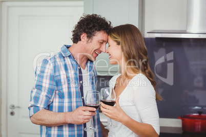 Young couple standing face to face in kitchen