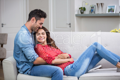 Romantic couple hugging on sofa