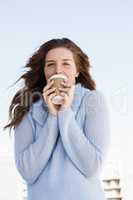 Happy young woman having coffee