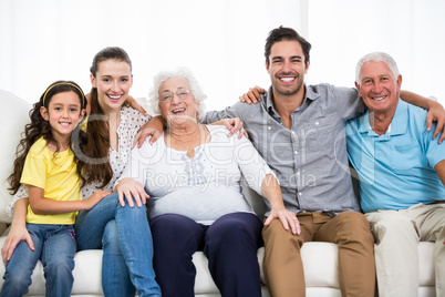 Portrait of smiling family with arm around