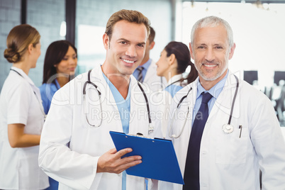 Two doctors with clipboard in hospital