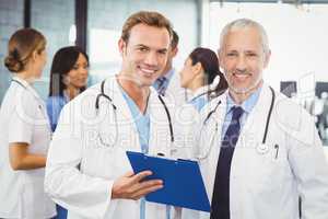 Two doctors with clipboard in hospital