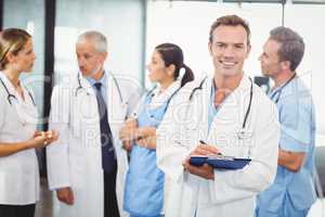 Male doctor writing on clipboard