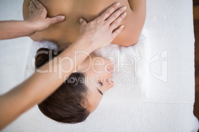 Young woman receiving back massage at spa
