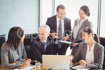 Businesspeople interacting in conference room