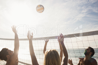 Friends playing beach volleyball