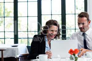 Business colleagues using a laptop while having a meeting