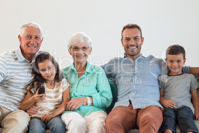 Happy family sitting on sofa