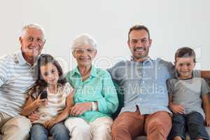 Happy family sitting on sofa