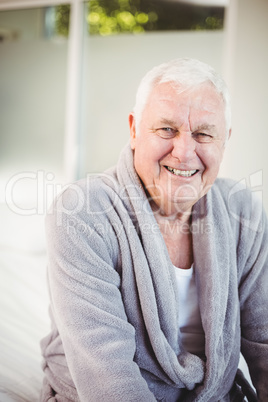 Smiling senior man in bedroom at home