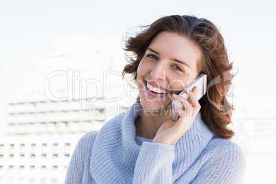 Happy young woman talking on mobile phone