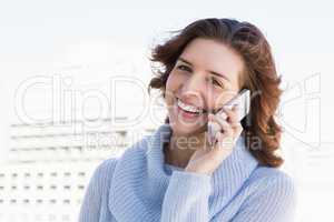 Happy young woman talking on mobile phone