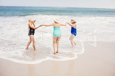 Senior woman friends playing in water