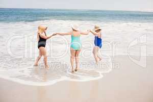 Senior woman friends playing in water