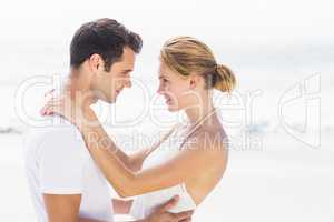 Young couple standing face to face and romancing