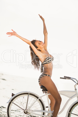 Brunette going on a bike ride on the beach
