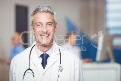 Portrait of smiling senior doctor