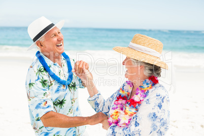 Senior couple dancing together at the beach