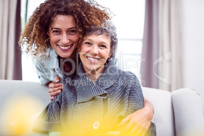 Happy woman cuddling mother