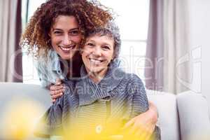 Happy woman cuddling mother