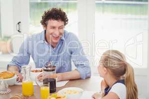 Daughter and father having breakfast