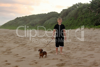 Boy Walking His Dogs on Beach