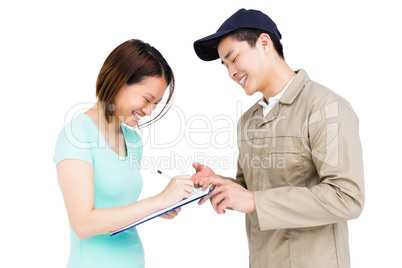 Delivery man taking signature of woman